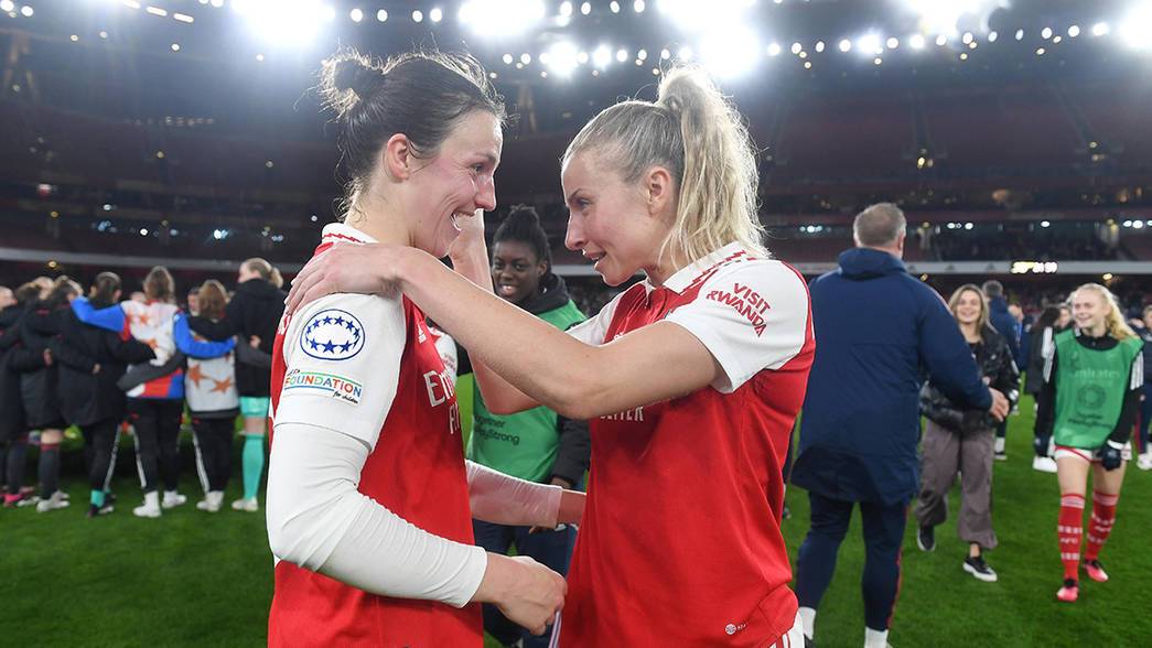 Lotte Wubben-Moy and Leah Williamson embrace under the Emirates Stadium lights
